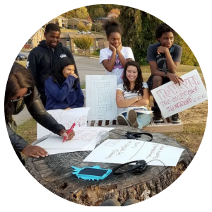 Photo of students making signs together.